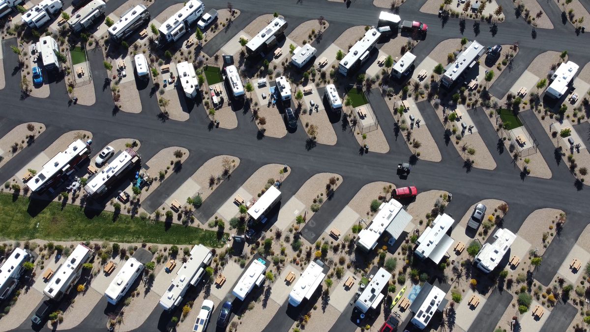 Overhead view of dozens of RVs parked in landscaped rows at a large RV resort